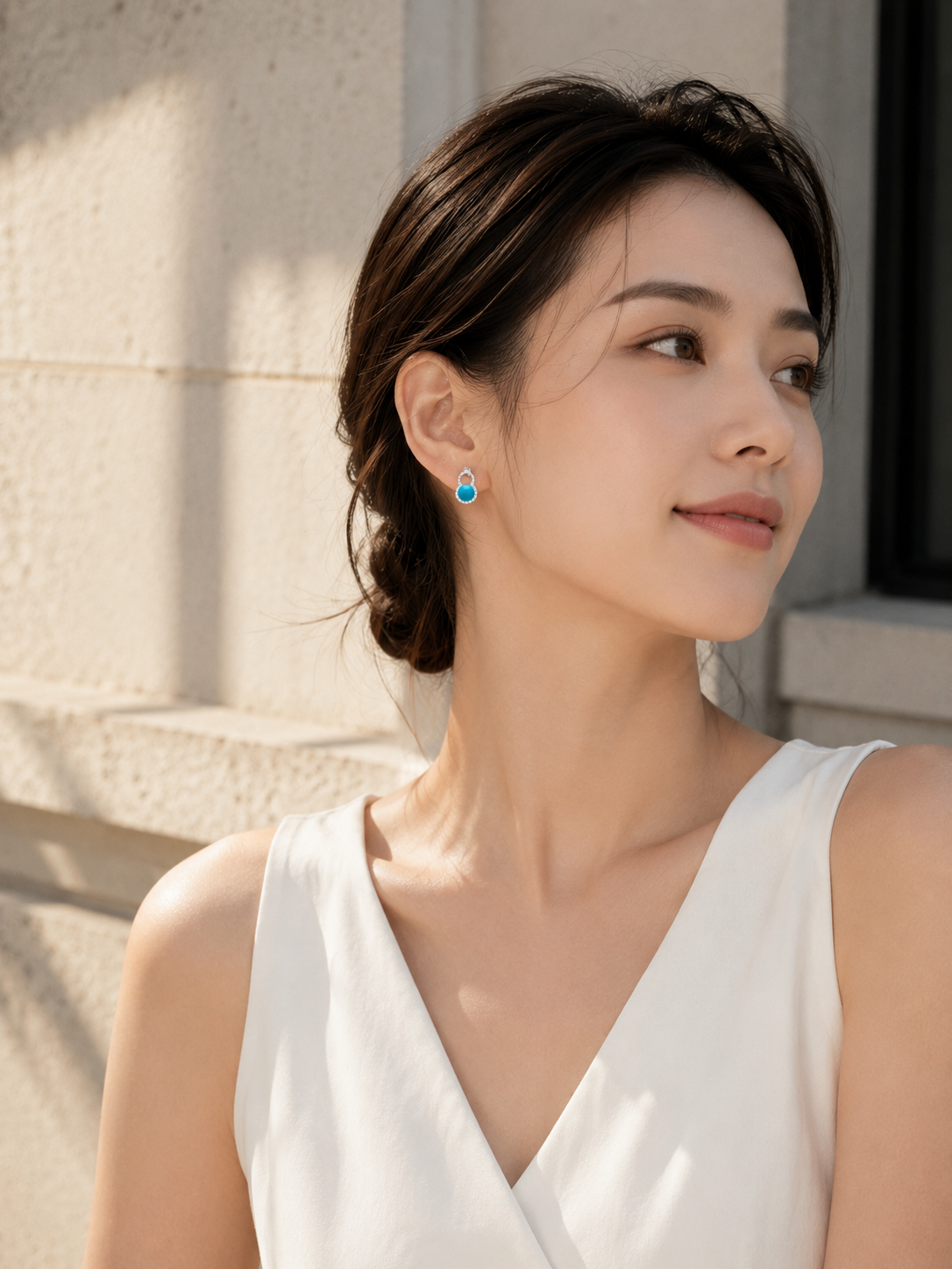 CARV. silver turquoise halo stud earrings worn on ear with teardrop setting and blue stone detail