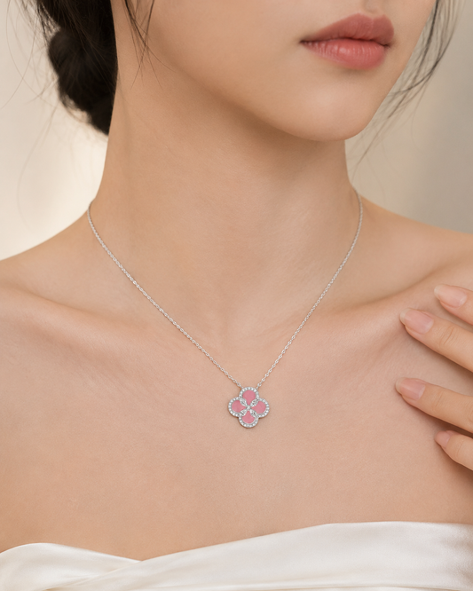 CARV. silver pink mother-of-pearl flower necklace worn at collarbone with four-petal pendant and crystal outline