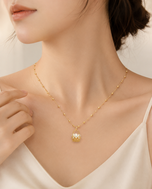CARV. gold pearl basket necklace worn at collarbone with pearl basket pendant and beaded chain