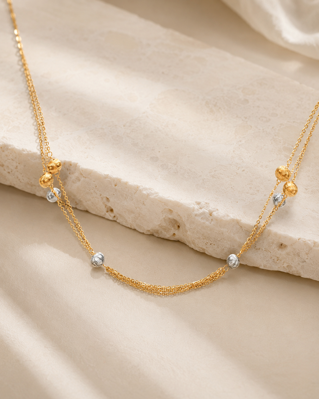 CARV. gold layered bead necklace with silver bead accents and double chain detail product display