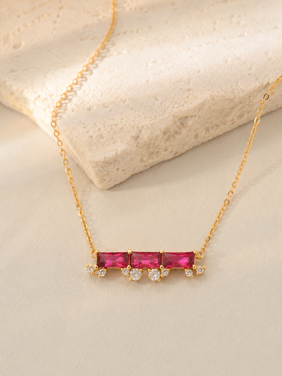 CARV. ruby bar necklace with horizontal pink stone bar, gold chain and small crystal drop detail