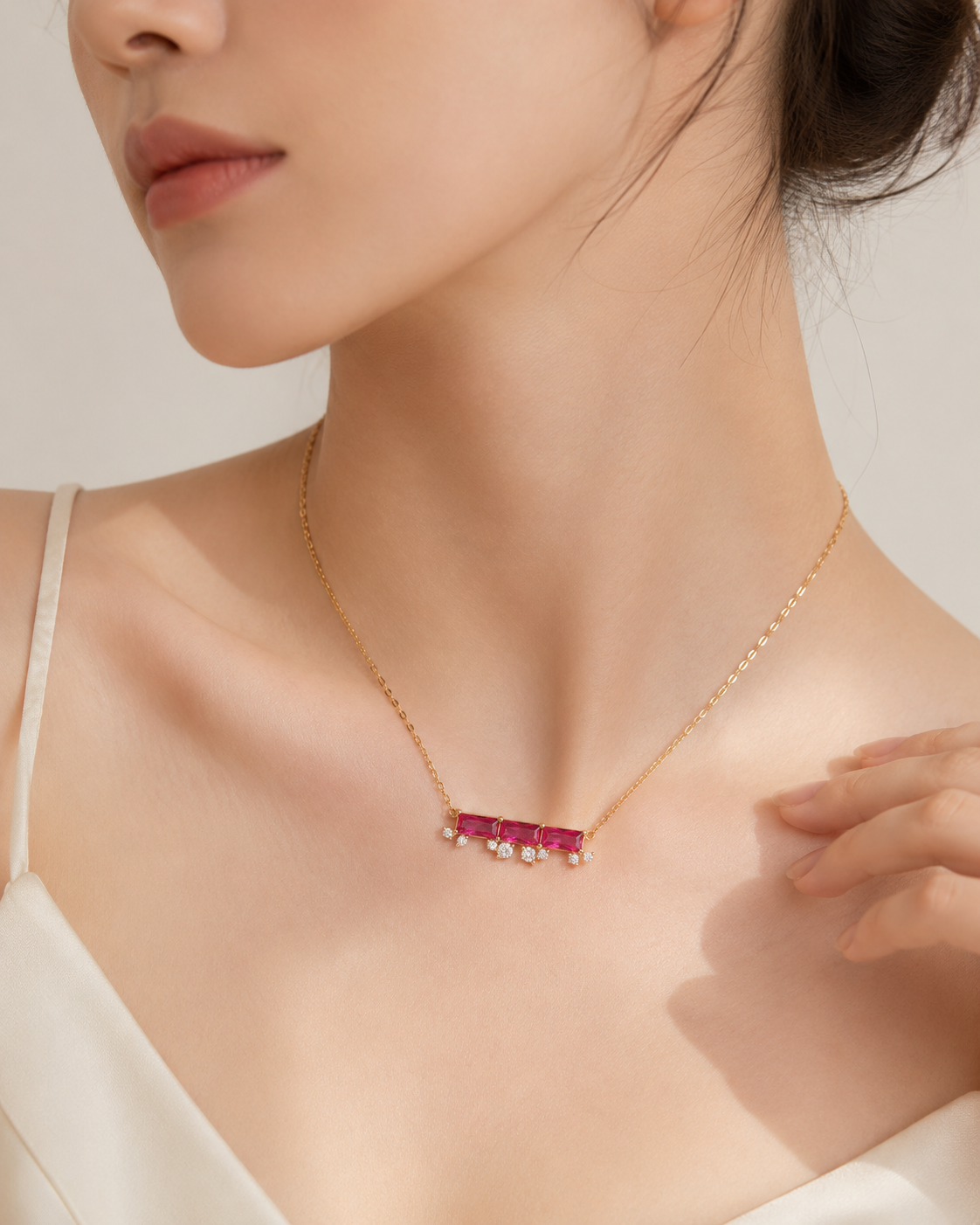 CARV. ruby bar necklace worn at collarbone with horizontal pink stone bar and gold chain