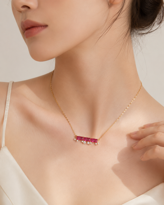 CARV. ruby bar necklace worn at collarbone with horizontal pink stone bar and gold chain