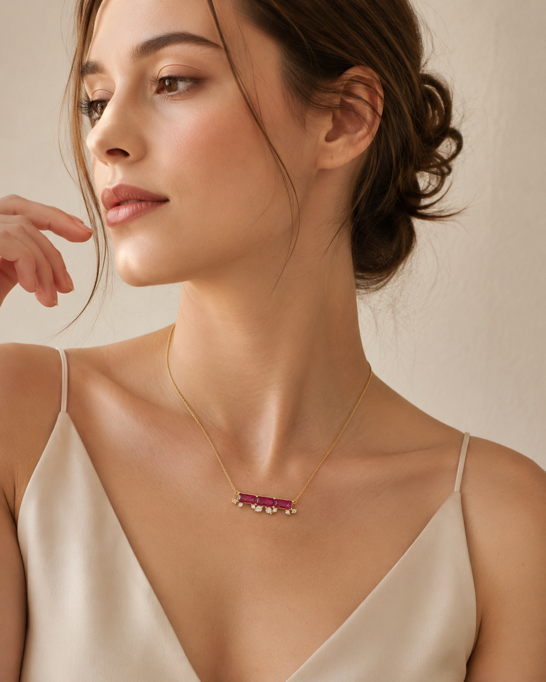 CARV. ruby bar necklace styled on neckline with pink rectangular stones and crystal drop accents