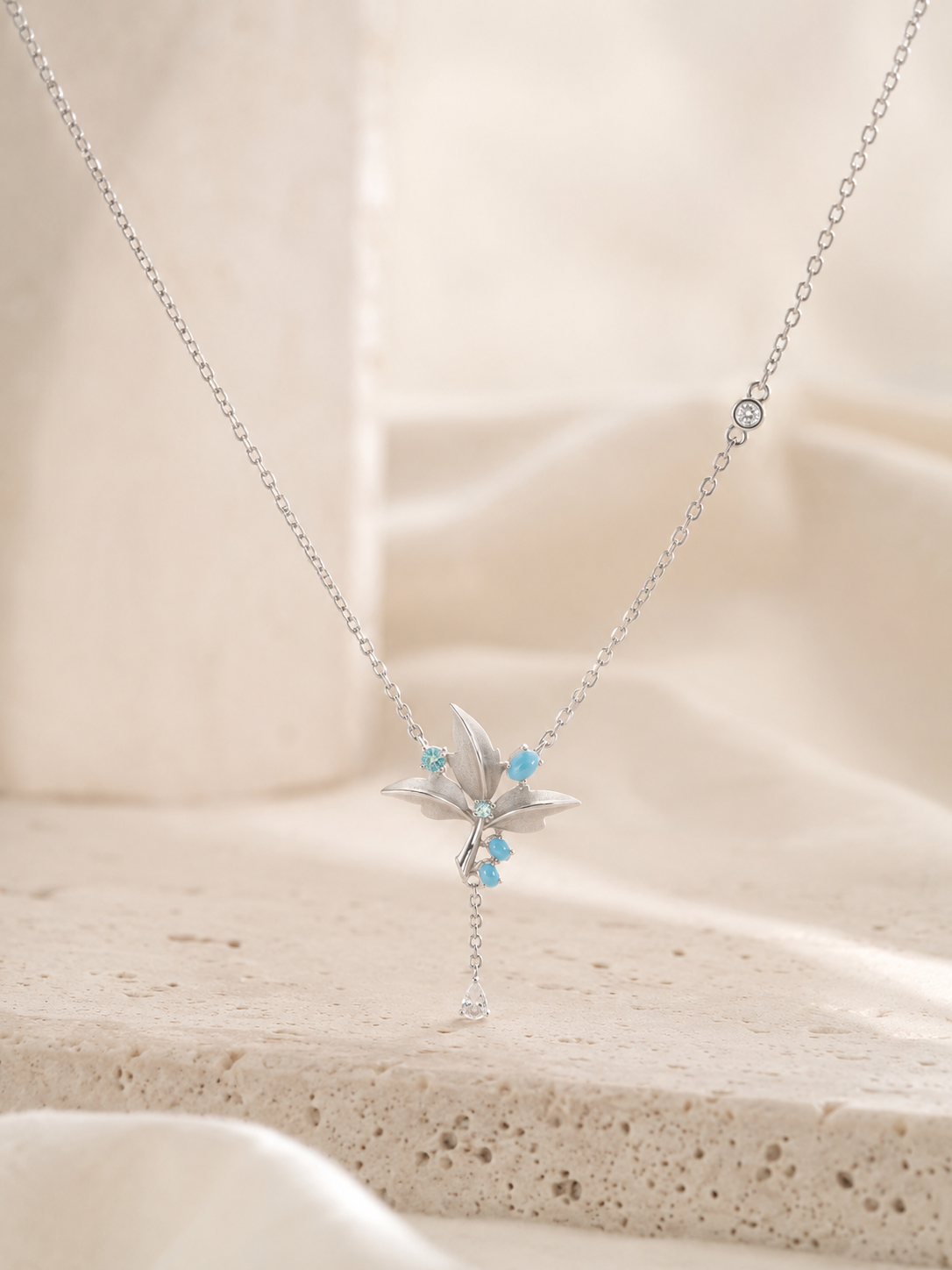CARV. silver lily pendant necklace with turquoise accent, layered petals and tassel drop detail