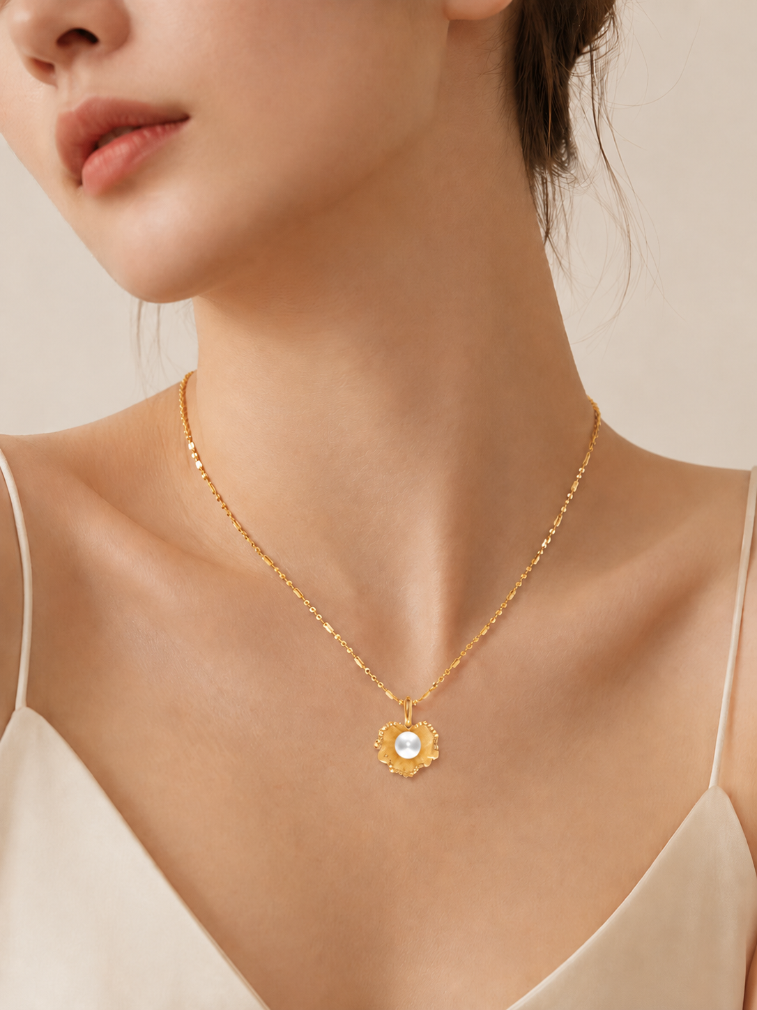CARV. gold pearl flower pendant necklace worn at collarbone with round pearl centre detail