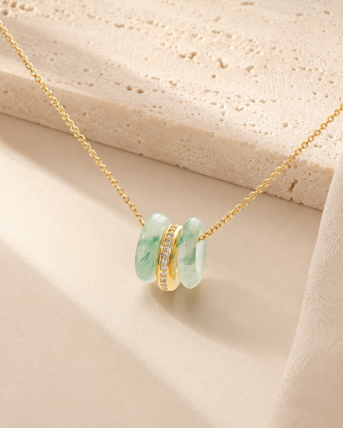 CARV. gold green stone orbit pendant necklace with triple hoop pendant on product display