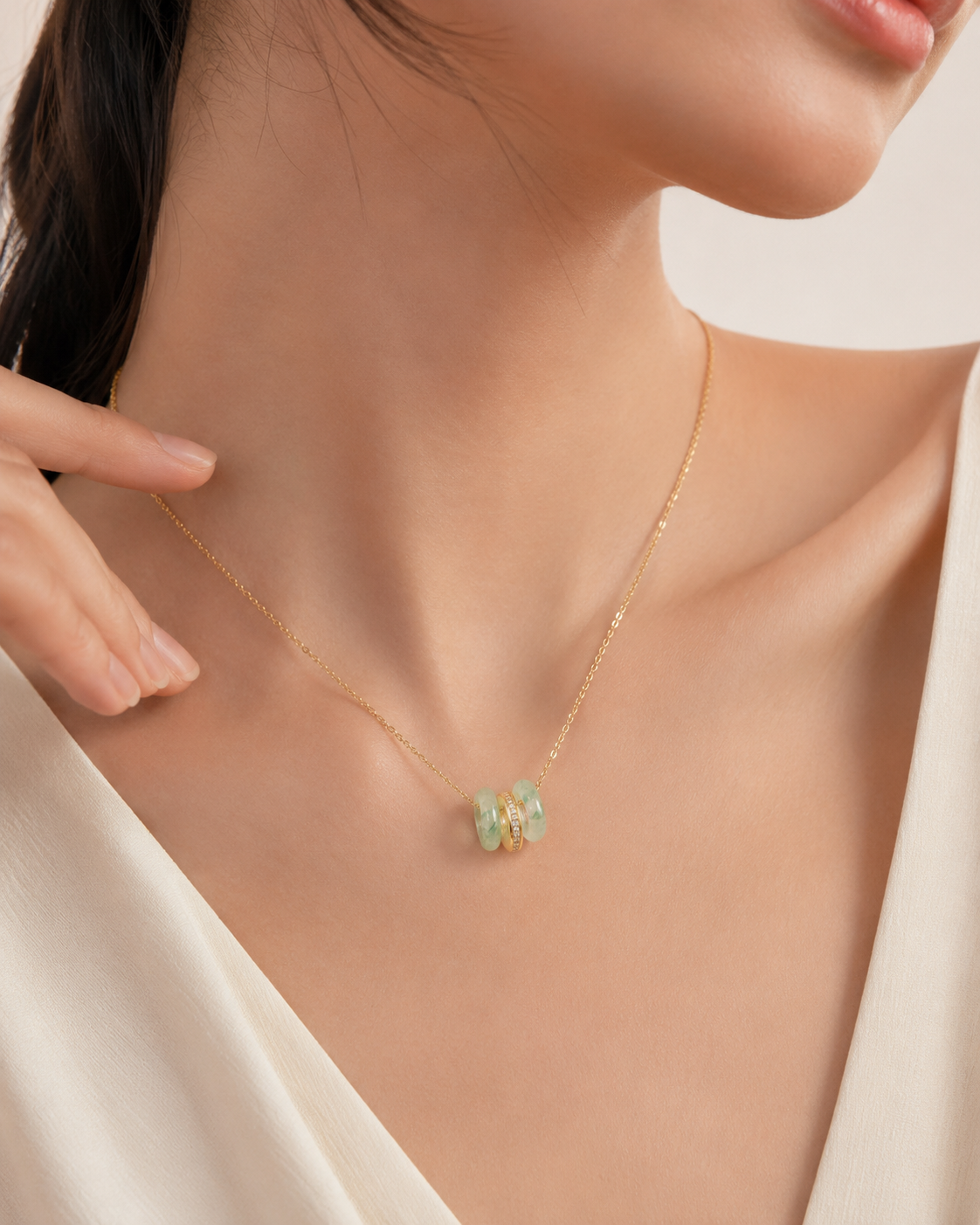 CARV. gold green stone orbit pendant necklace worn at collarbone with triple hoop pendant