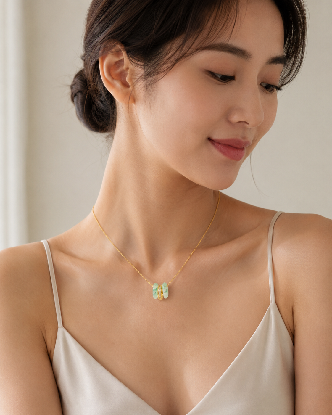 CARV. gold green stone orbit pendant necklace worn at collarbone with triple hoop design