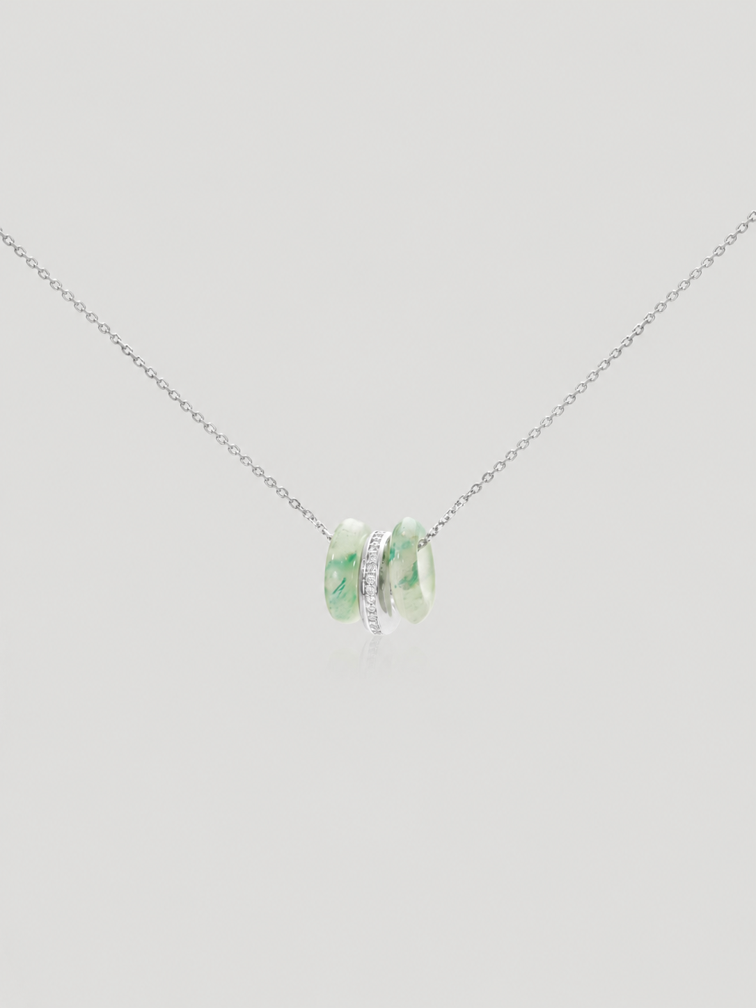 CARV. silver green stone orbit pendant necklace with triple hoop design and pavé center ring