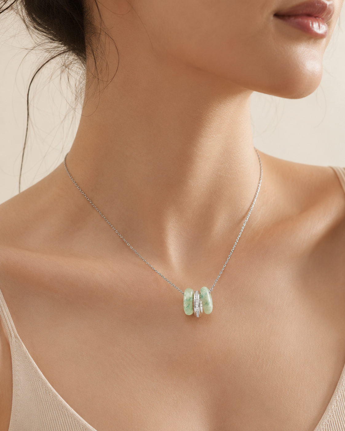 CARV. silver green stone orbit pendant necklace worn at collarbone with triple hoop pendant