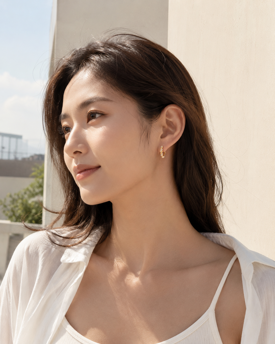 CARV. gold twisted pavé hoop earrings worn on ear in side profile