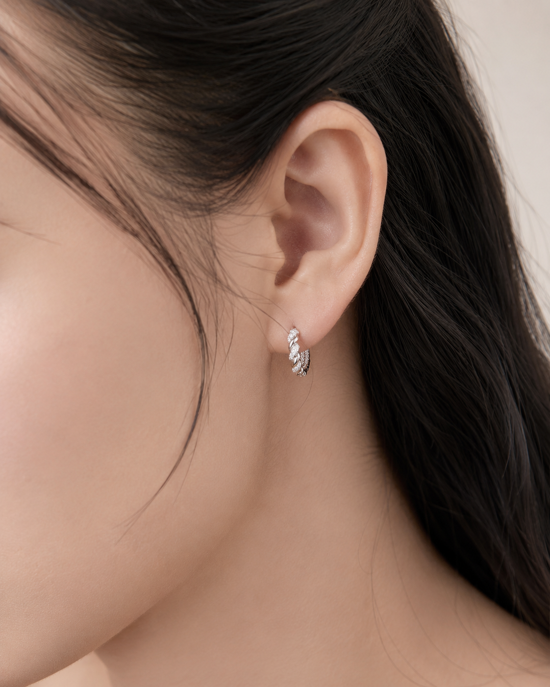 CARV. silver twisted pavé hoop earrings worn on ear with rope twist detail