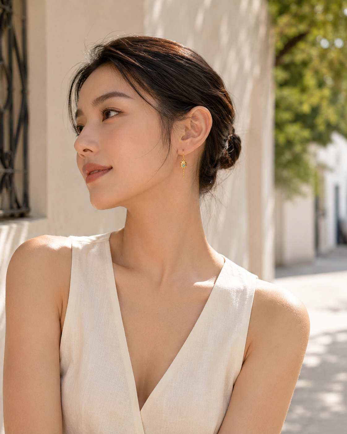 CARV. gold lantern drop earrings with turquoise detail worn on ear
