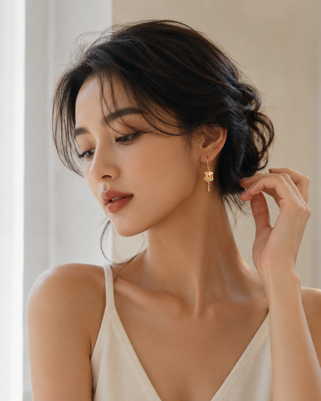 CARV. gold lantern drop earrings with turquoise detail worn on ear