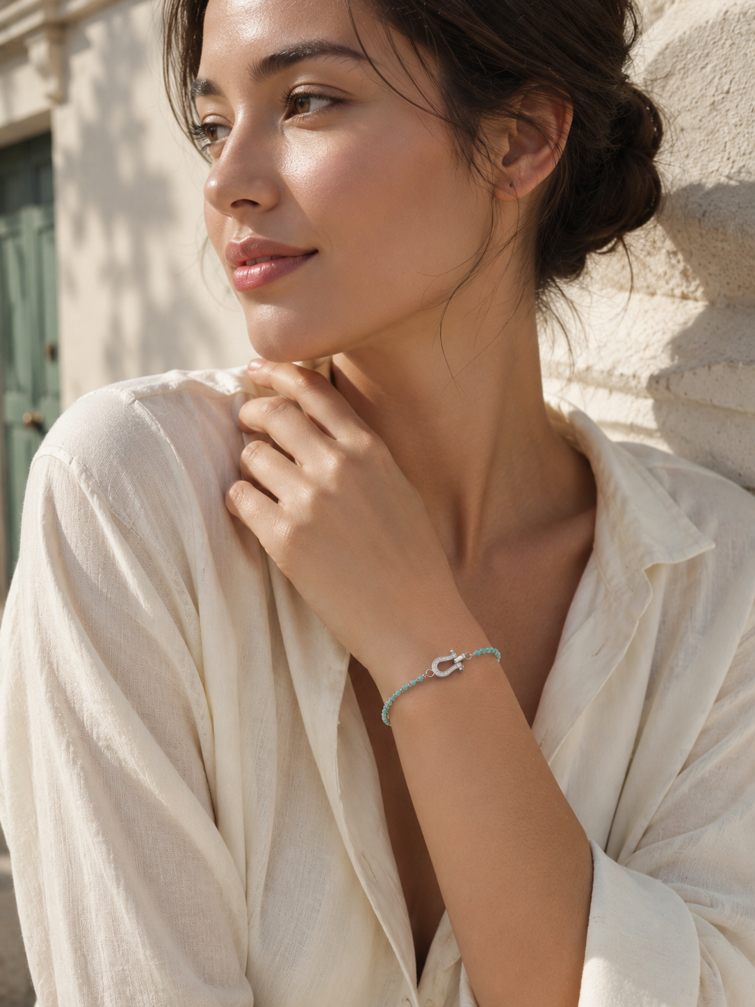 CARV. turquoise beaded bracelet with silver bar accent worn on wrist with delicate chain detail
