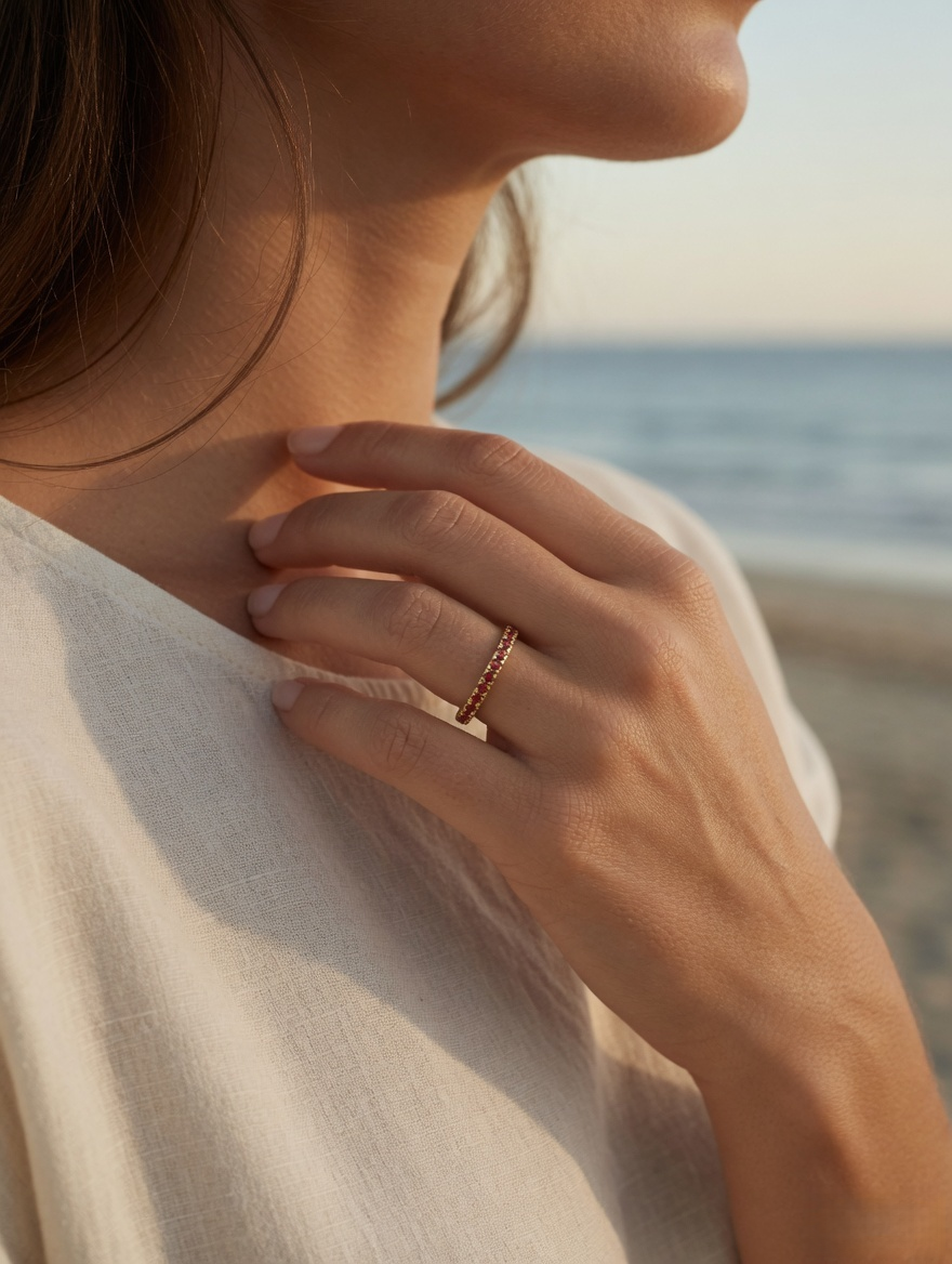 CARV. gold red stone band ring shown on hand with slim silhouette and red stone band detail