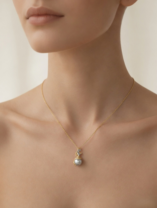 CARV. gold pearl pendant necklace worn at collarbone with grey pearl drop and zircon accent