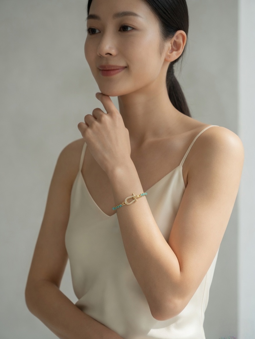 CARV. turquoise beaded bracelet with gold bar accent worn on wrist with delicate chain detail