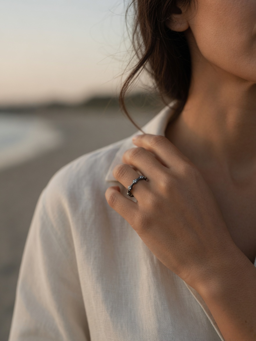 CARV. black flower ring worn on hand with irregular floral band design