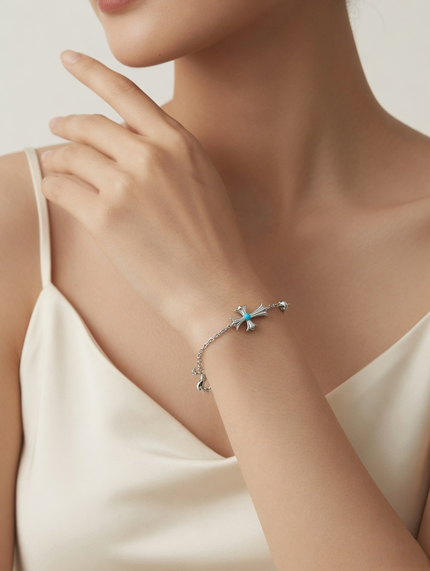 CARV. silver cross bracelet with turquoise accent worn on wrist in close-up styling