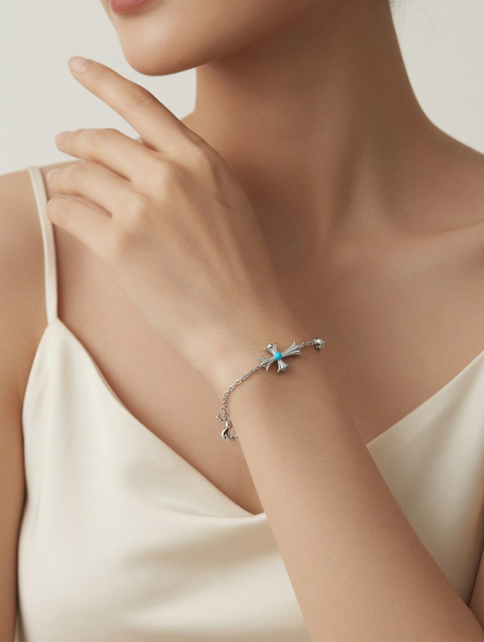 CARV. silver cross bracelet with turquoise accent worn on wrist in close-up styling