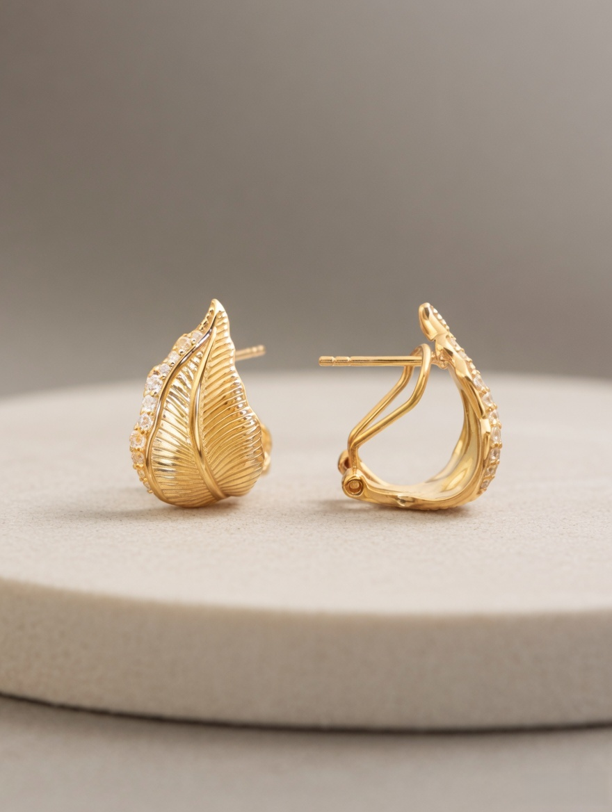 CARV. gold leaf stud earrings with pavé detail and curved leaf silhouette product display