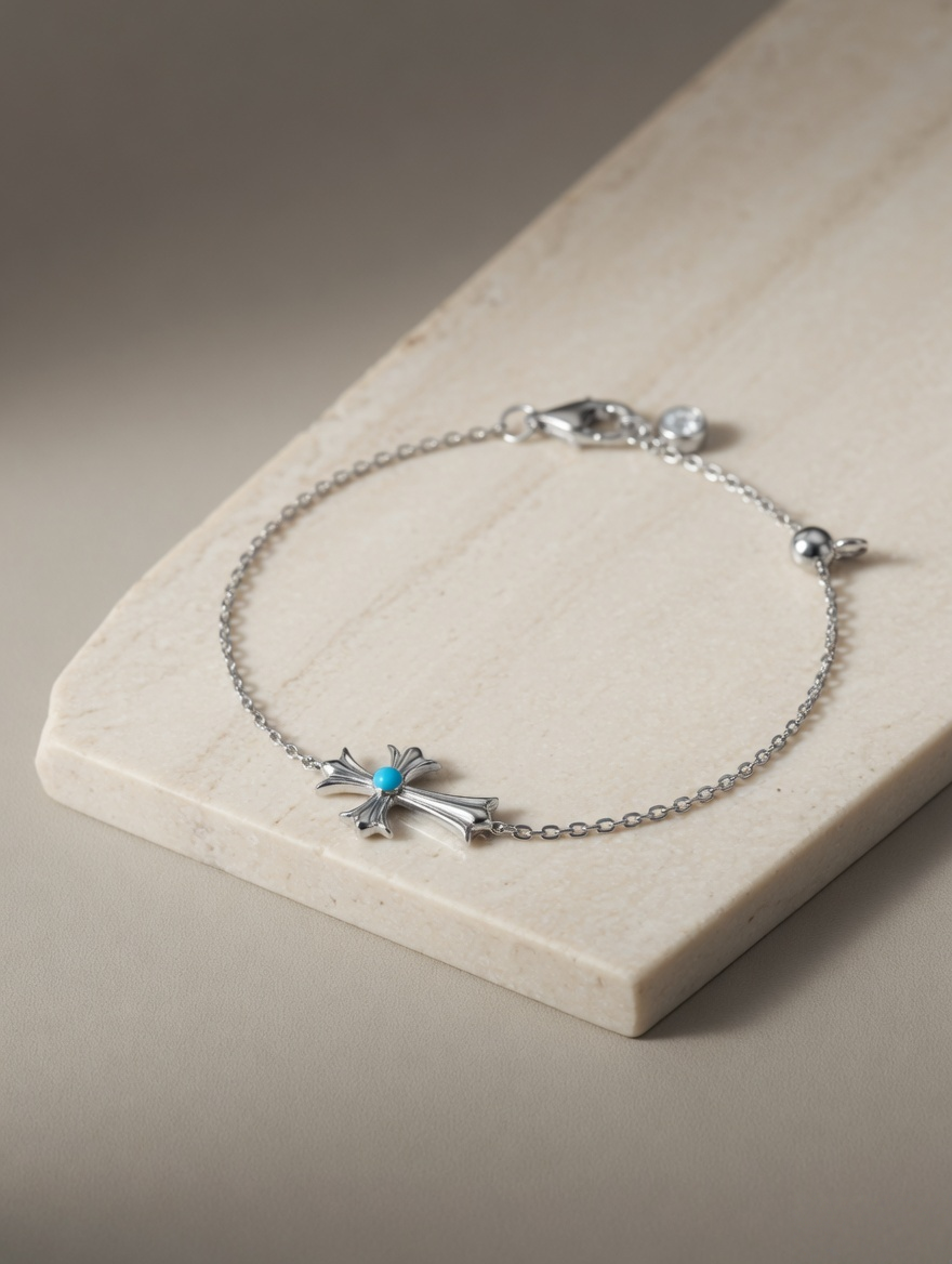 CARV. silver cross bracelet with turquoise centre accent, fine chain and adjustable clasp detail