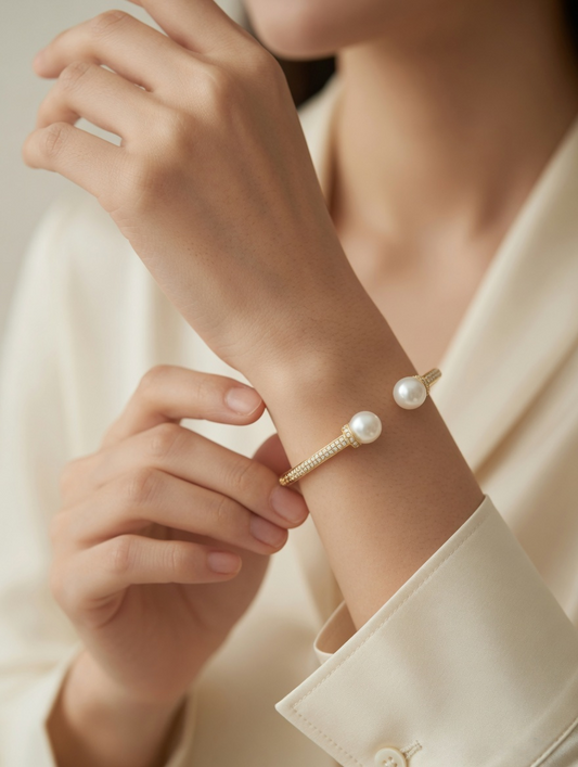 CARV. gold pearl open cuff bangle worn on wrist