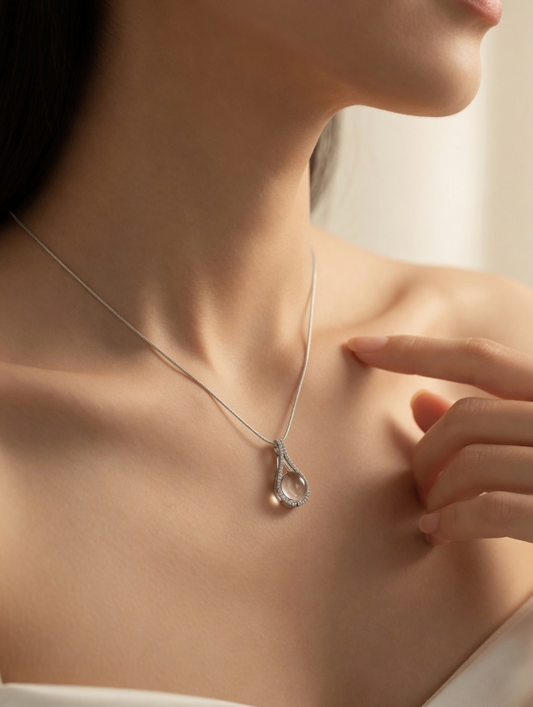 CARV. silver teardrop white crystal pendant worn at collarbone with pavé outline and white crystal centre