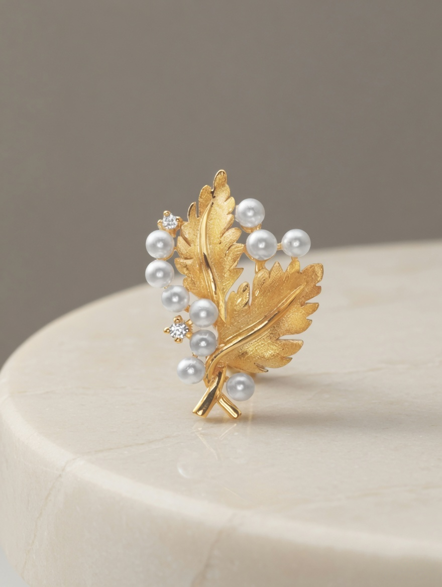 CARV. gold oak leaf pearl pendant necklace with textured leaf pendant and white pearl cluster on display