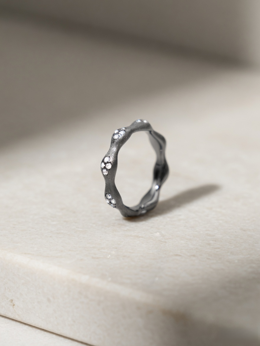 CARV. black flower ring with irregular petal band, crystal accents and dark metal finish on display