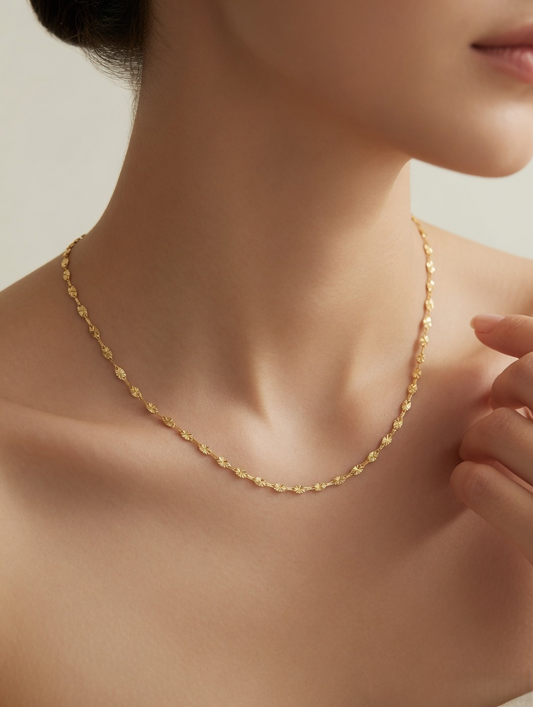 CARV. gold facet single chain necklace with elongated faceted links worn on neck