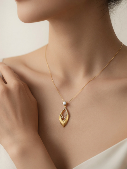 CARV. gold openwork marquise pendant necklace worn at collarbone with crystal flower detail