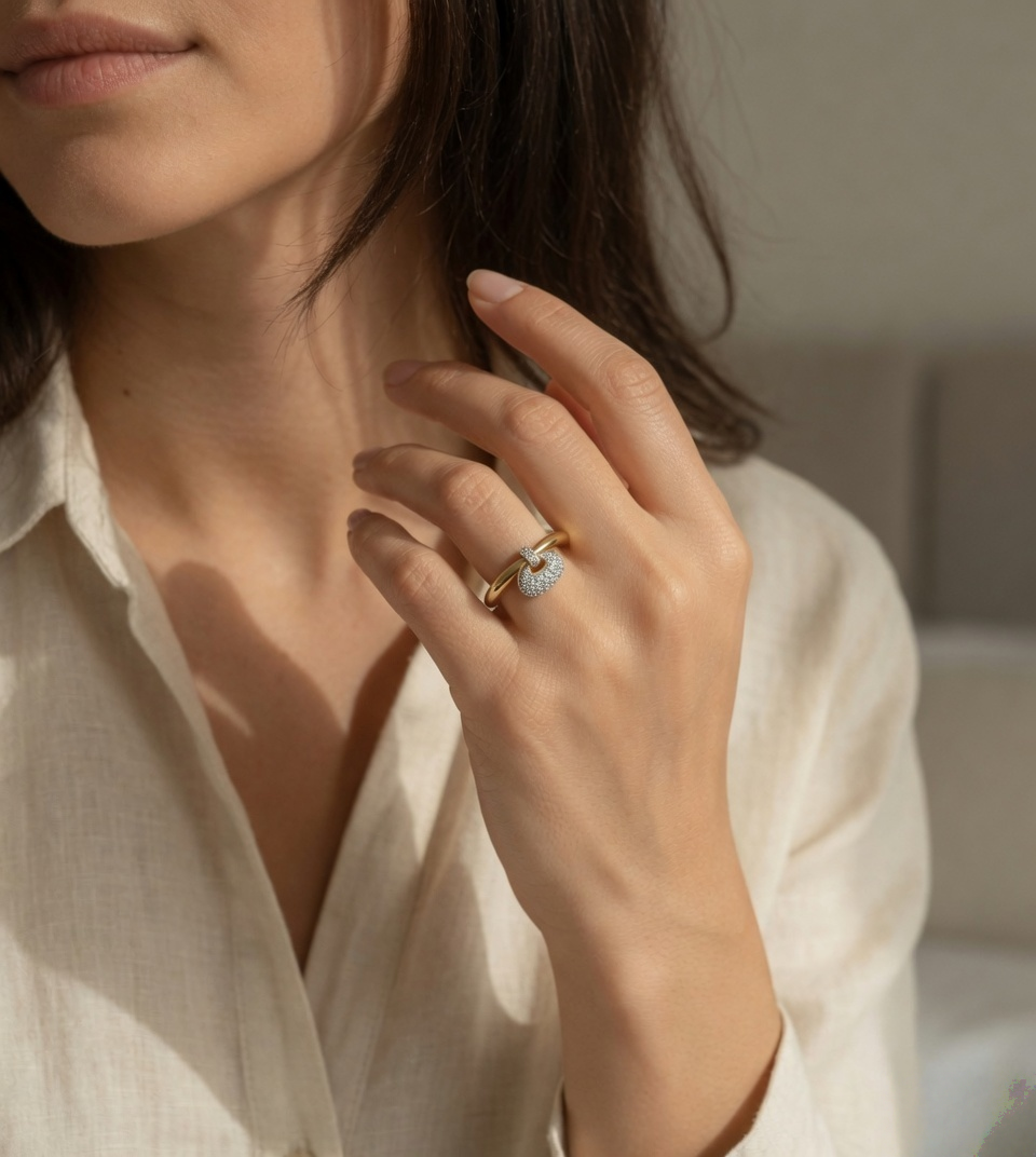 CARV. gold bag charm ring worn on hand with polished band and round pavé charm detail