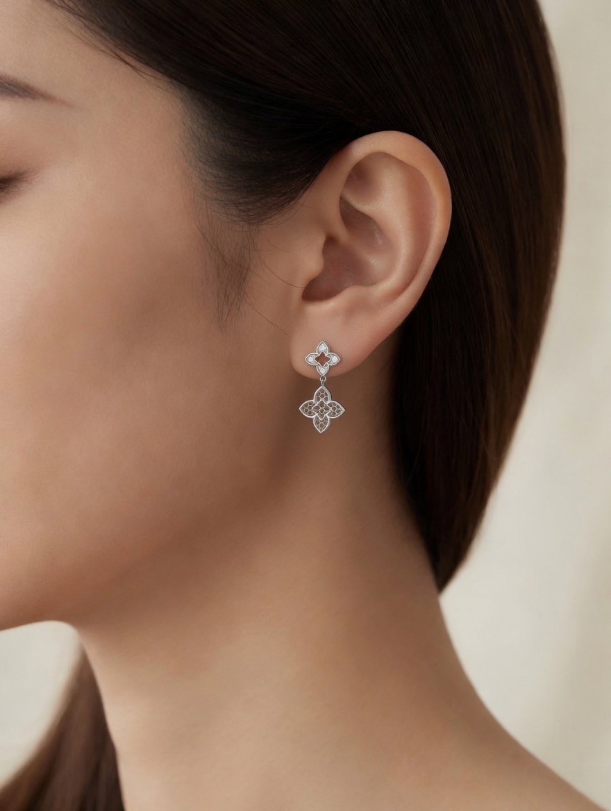 CARV. silver clover drop earrings worn on ear close-up