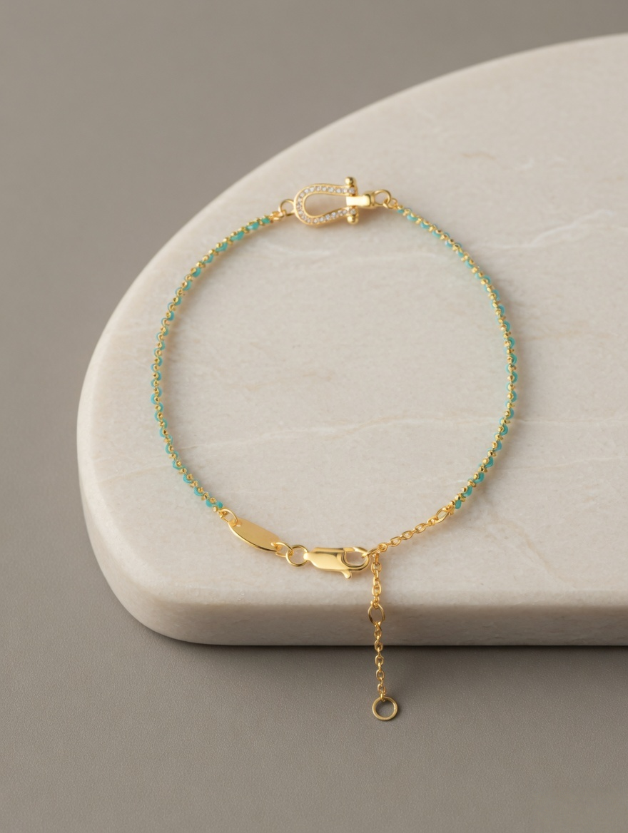 CARV. turquoise beaded bracelet with gold bar accent, clasp and adjustable chain detail