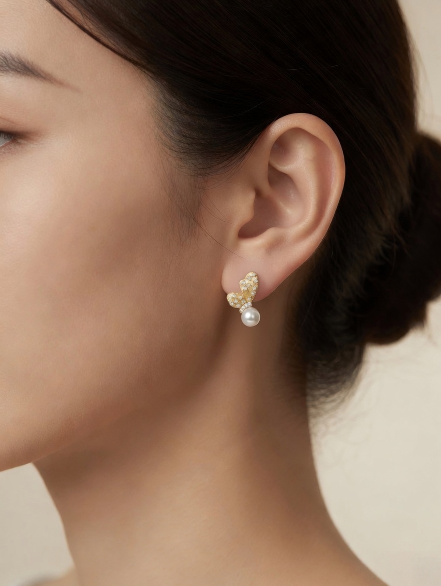 CARV. gold pearl floral stud earrings worn on ear with pavé petals and round pearl drop