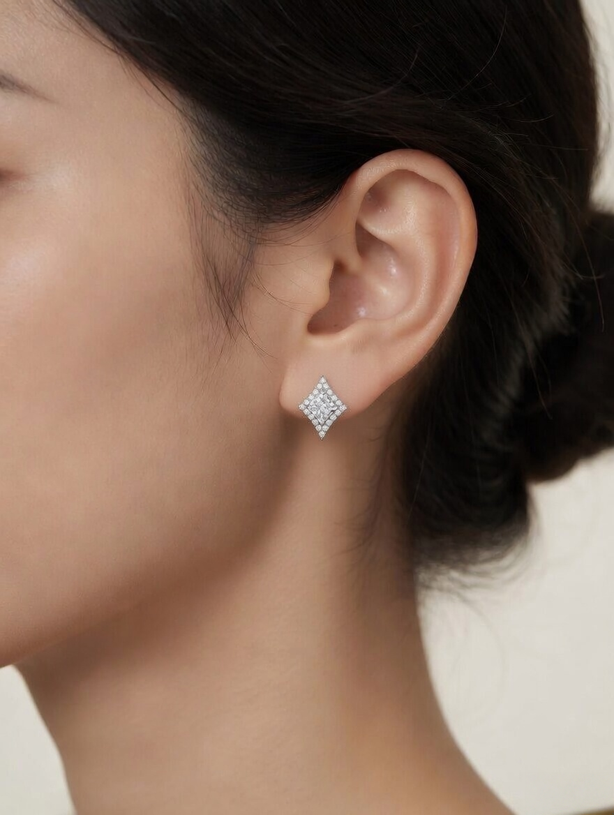 CARV. silver diamond lattice stud earrings with pavé border worn on ear