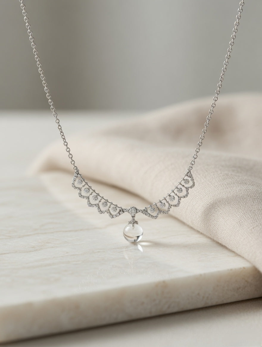 CARV. silver crystal drop necklace with scalloped crystal detail and round drop pendant on display
